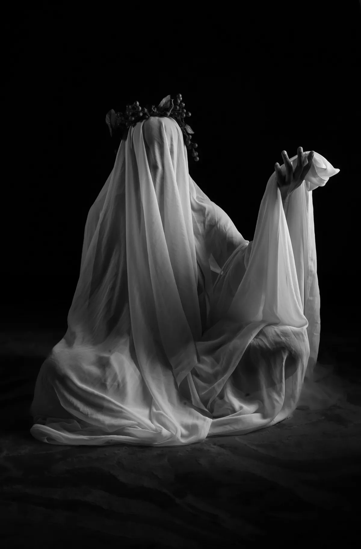 Creative abstract portrait of Natacha Boodhoo moving beneath flowing white fabric