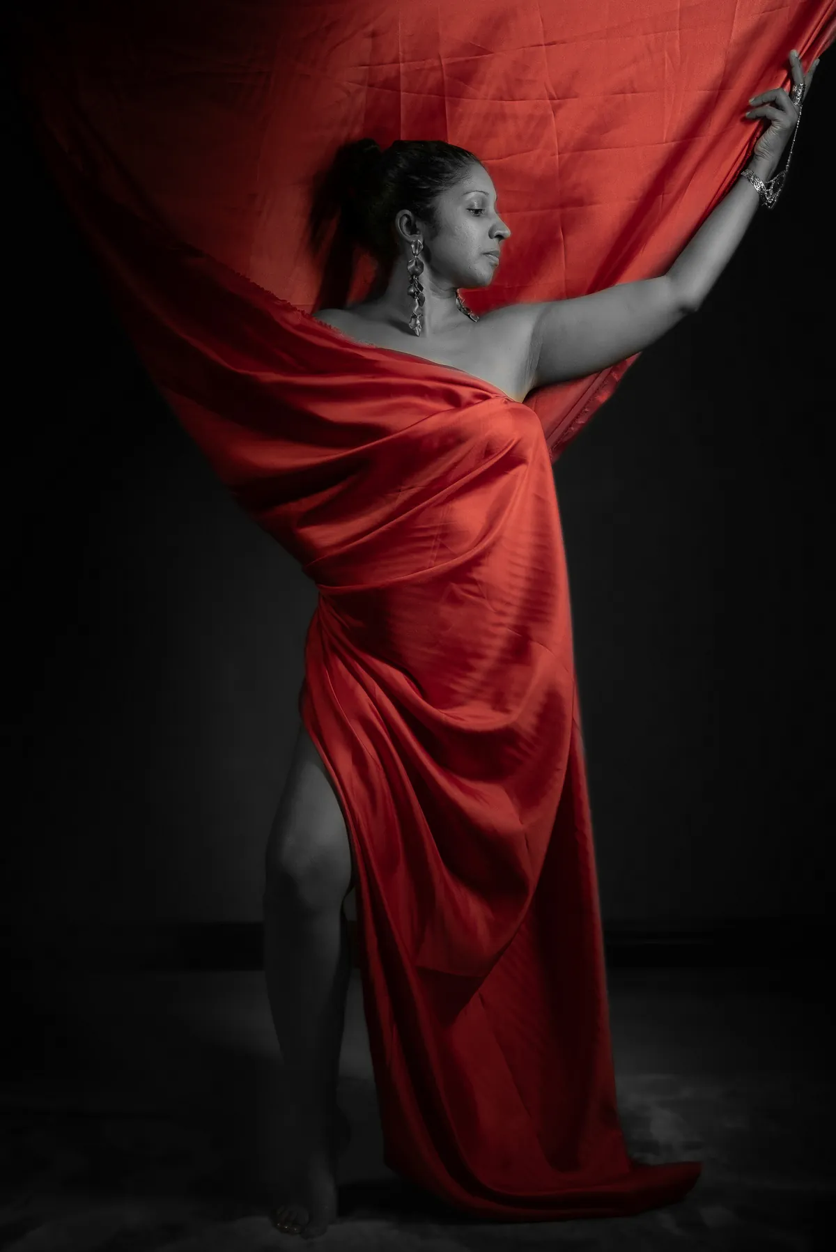 Dramatic creative portrait of Natacha Boodhoo framed by flowing red fabric