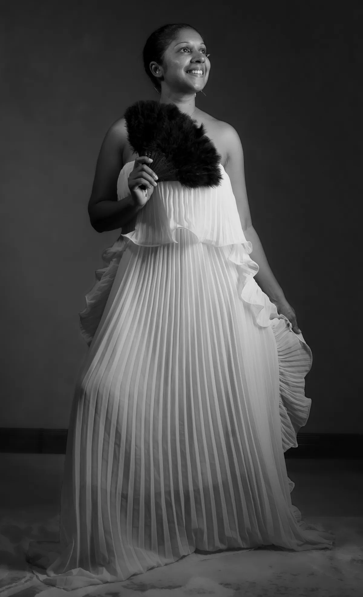 Full-length glamour portrait of Natacha Boodhoo wearing layered white tulle