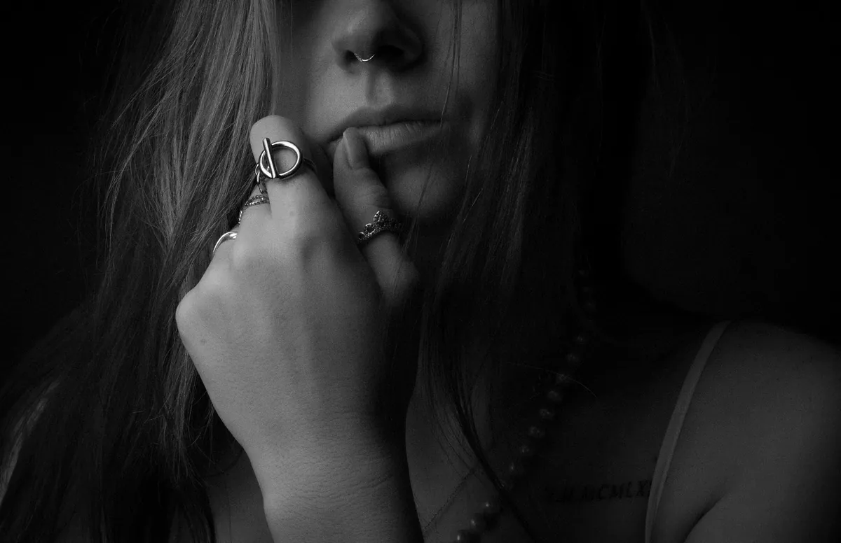 Close-up black-and-white portrait of Thaiss Windenberger with her face partly in shadow