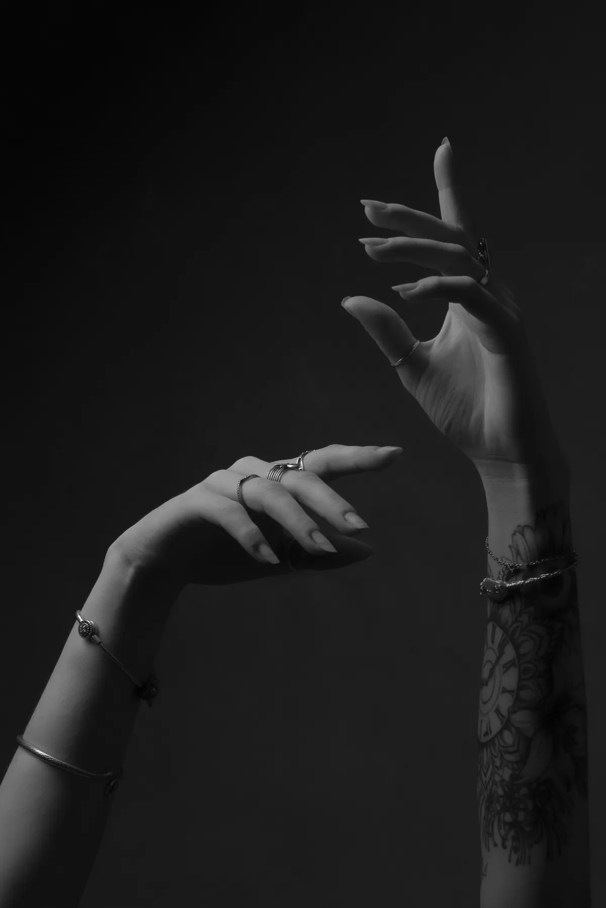 Artistic black-and-white detail portrait focusing on Thaiss Windenberger's hands and arms
