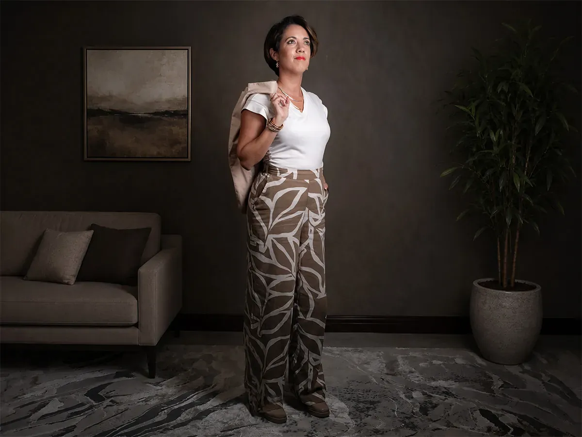 Full-length photograph of Martine Drouin posing in a furnished studio setting