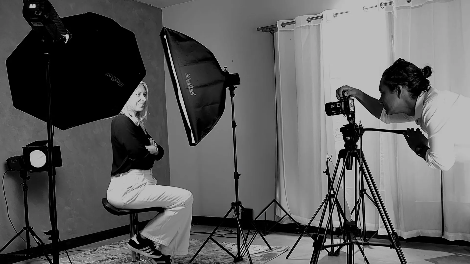 Kurt photographing a client among studio lights and camera equipment in Albion