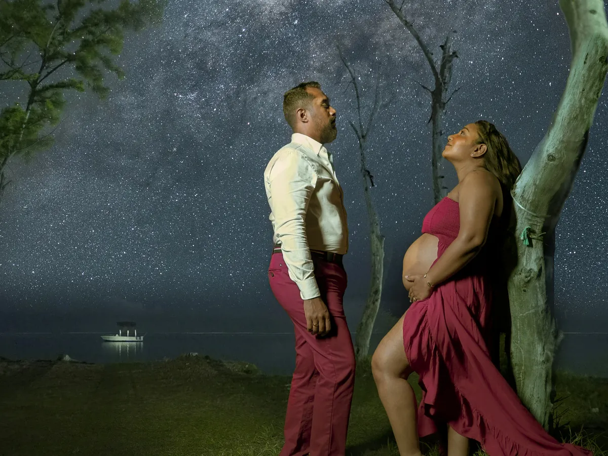 Couple illuminated beneath the Milky Way during a night portrait session in Mauritius
